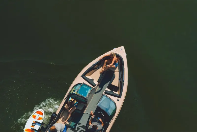 Slide: The Image of Aerial view of 2022 MasterCraft XT25 boat with people enjoying the water. - 17