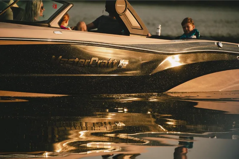 Slide: The Image of 2022 MasterCraft XT25 boat on water with passengers. - 3