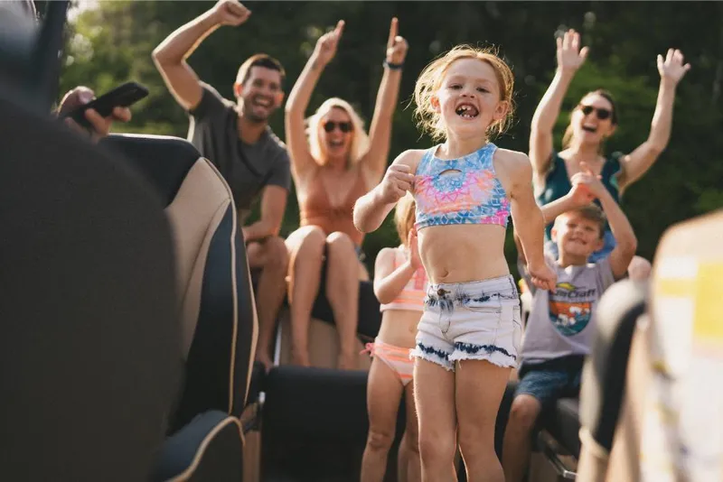 Slide: The Image of Family enjoying a day on a 2022 MasterCraft XT25 boat. - 5