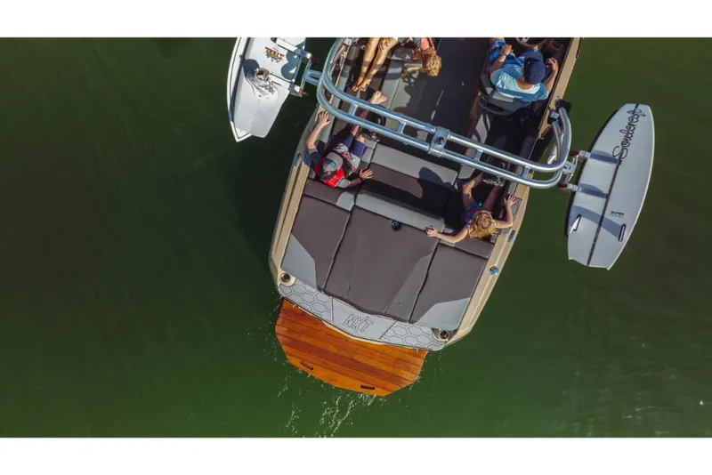 Slide: The Image of Aerial view of 2023 MasterCraft NXT20 boat with passengers on a lake. - 2