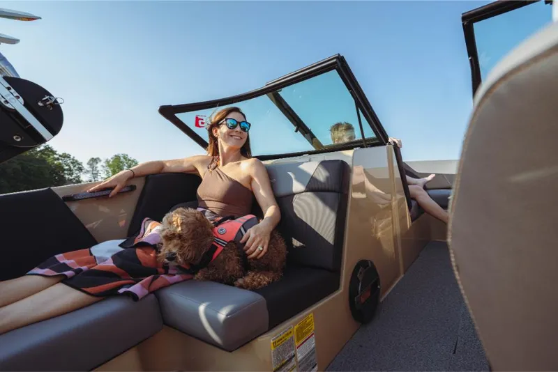 Slide: The Image of Woman and dog relaxing on a 2023 MasterCraft NXT20 boat. - 25