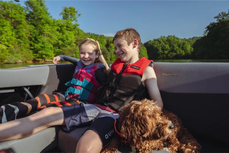 Slide: The Image of Children and dog enjoying a ride on a 2023 MasterCraft NXT20 boat. - 4