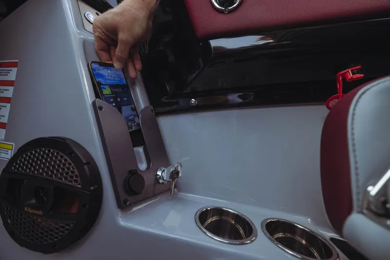 Slide: The Image of 2023 MasterCraft NXT22 boat interior with smartphone holder and speaker. - 10