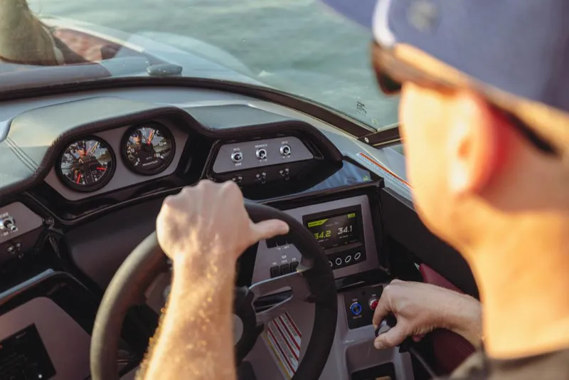 Slide: The Image of 2023 MasterCraft NXT22 boat dashboard with driver on water - 11