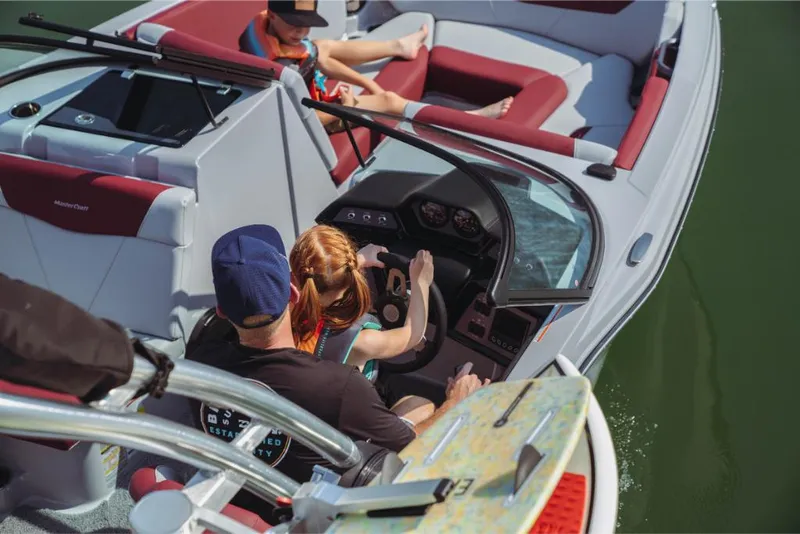 Slide: The Image of 2023 MasterCraft NXT22 boat with family enjoying a day on the water. - 3