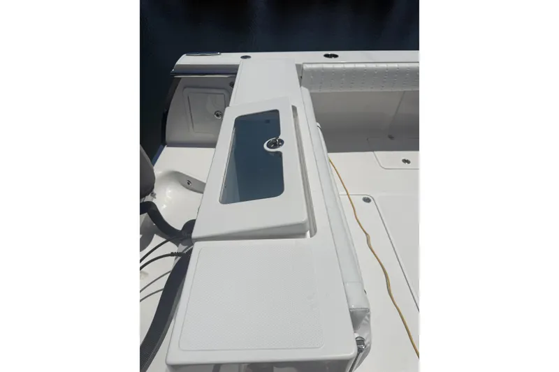 Slide: The Image of 2015 Southport 33 FE boat deck with storage compartment and seating area. - 10
