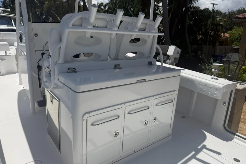 Slide: The Image of 2015 Southport 33 FE boat interior with white seating and storage compartments. - 11