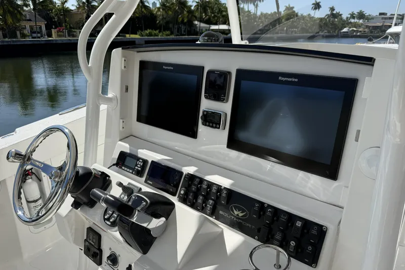Slide: The Image of Helm of 2015 Southport 33 FE boat with dual Raymarine displays and controls. - 16