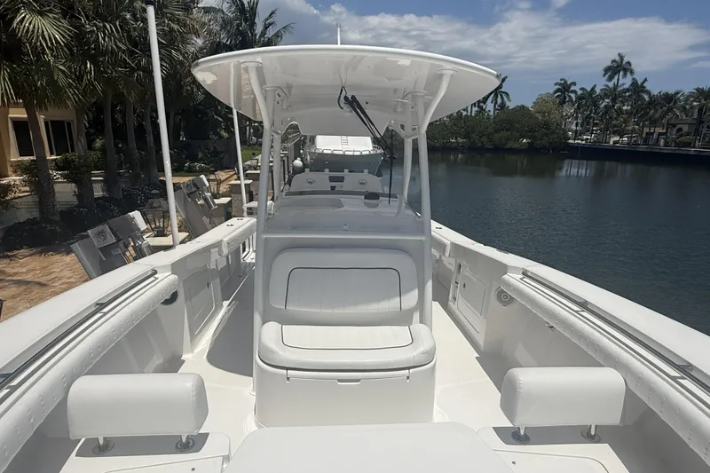 Slide: The Image of 2015 Southport 33 FE boat docked by a scenic waterfront with palm trees. - 18