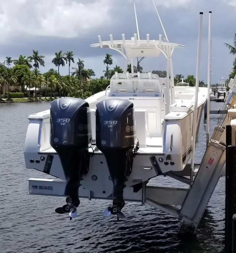 Slide: The Image of 2015 Southport 33 FE boat with twin outboard engines at dock. - 2