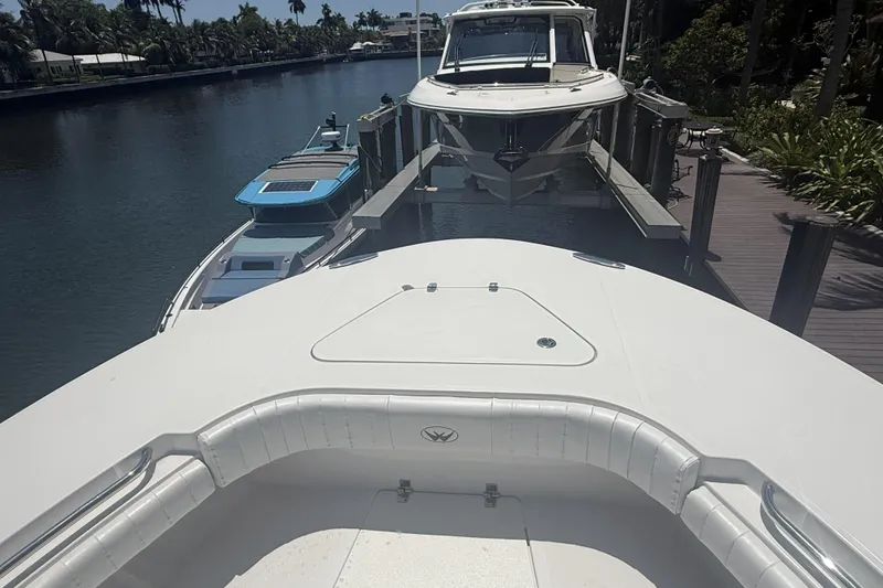 Slide: The Image of 2015 Southport 33 FE boat docked on a serene canal with lush surroundings. - 21