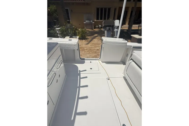 Slide: The Image of 2015 Southport 33 FE boat deck with seating and storage compartments. - 25