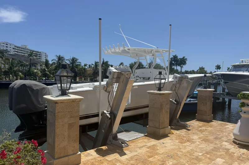 Slide: The Image of 2015 Southport 33 FE boat docked on a sunny waterfront with palm trees. - 4