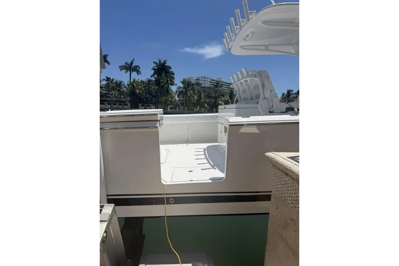 Slide: The Image of 2015 Southport 33 FE boat docked under clear blue sky with palm trees. - 5