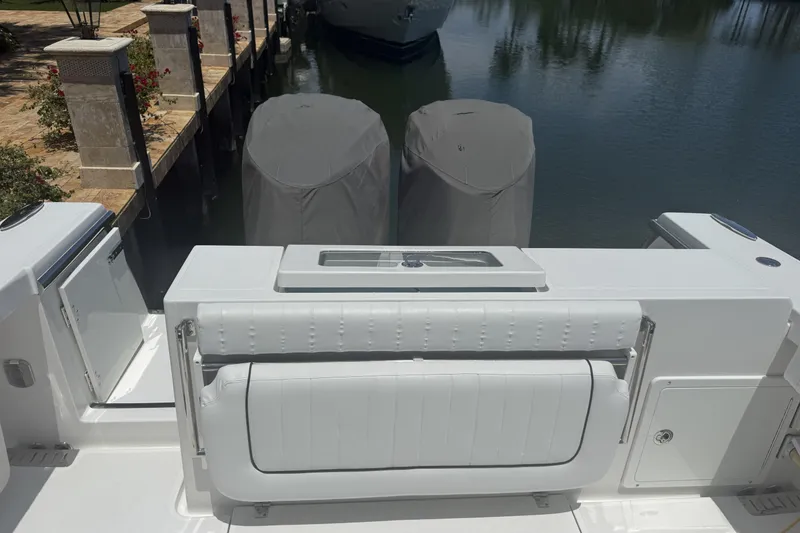 Slide: The Image of 2015 Southport 33 FE boat with covered engines docked by the water. - 7