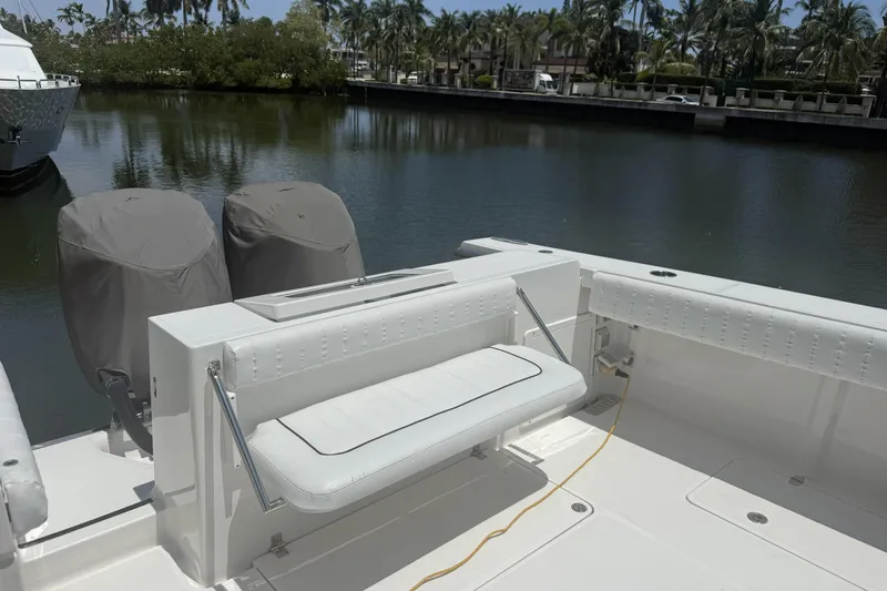 Slide: The Image of 2015 Southport 33 FE boat with covered engines, docked by a serene waterfront. - 8