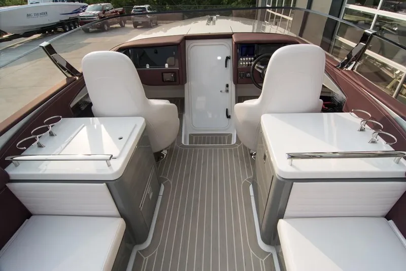 Slide: The Image of 2019 Donzi 41 GT boat interior with white seating and modern dashboard. - 16