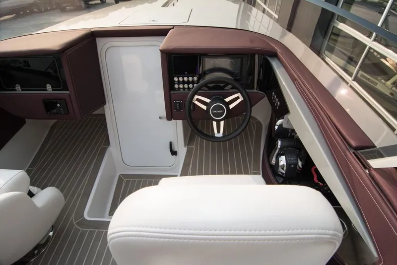 Slide: The Image of 2019 Donzi 41 GT boat cockpit with steering wheel and control panel. - 23