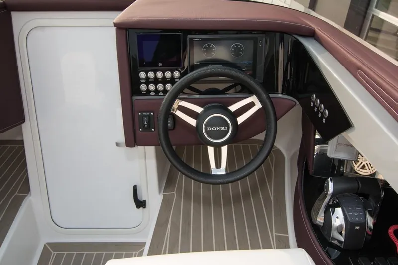 Slide: The Image of 2019 Donzi 41 GT boat cockpit with steering wheel and control panel. - 24