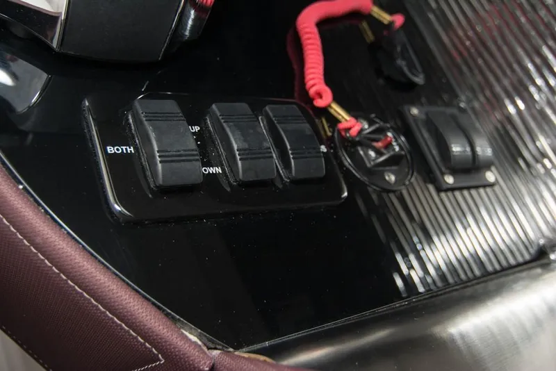 Slide: The Image of Control panel of a 2019 Donzi 41 GT boat with switches and safety lanyard. - 32