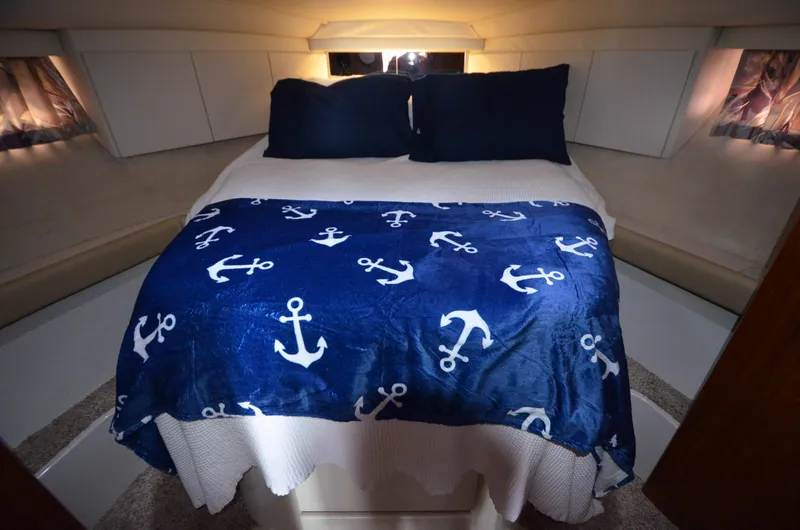 Slide: The Image of Cozy bedroom in 1995 Carver 370 Voyager with nautical-themed bedding. - 11