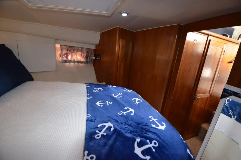 Slide: The Image of Cozy bedroom in 1995 Carver 370 Voyager with nautical-themed bedding. - 12