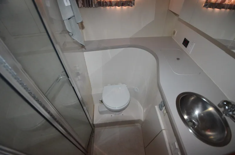 Slide: The Image of Bathroom interior of 1995 Carver 370 Voyager yacht with sink, toilet, and shower. - 15