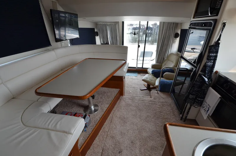 Slide: The Image of Interior of a 1995 Carver 370 Voyager yacht with dining area and lounge. - 16