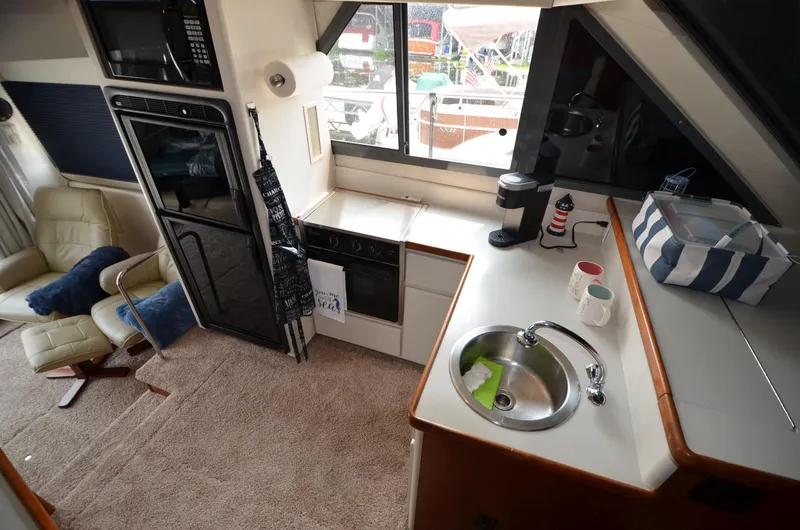 Slide: The Image of Interior of 1995 Carver 370 Voyager yacht kitchen and lounge area. - 19
