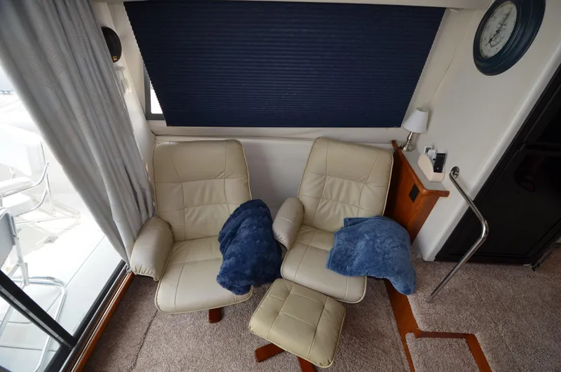 Slide: The Image of Interior of 1995 Carver 370 Voyager with beige leather chairs and blue blankets. - 20