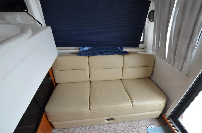 Slide: The Image of 1995 Carver 370 Voyager interior with beige leather sofa and blue window shade. - 21