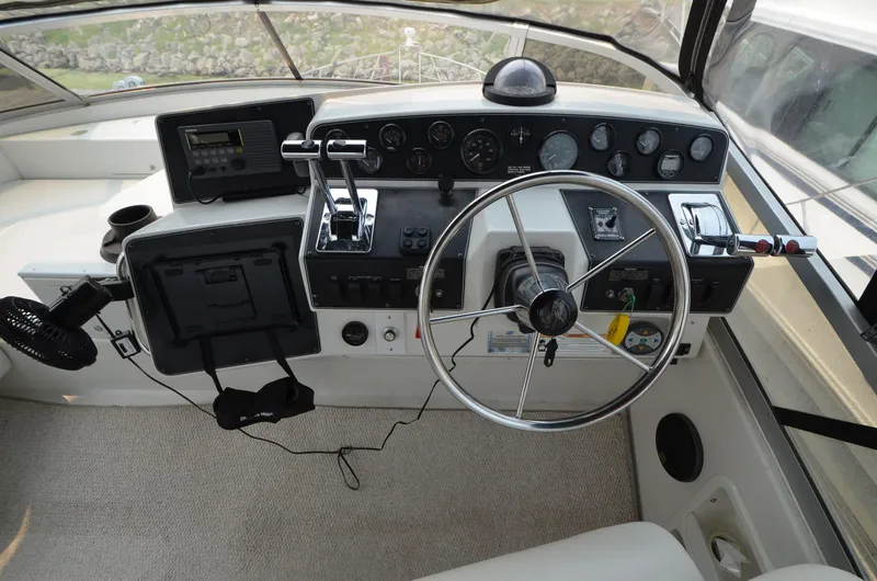 Slide: The Image of 1995 Carver 370 Voyager helm with steering wheel and control panel. - 9