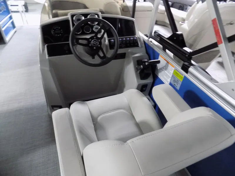 Slide: The Image of 2023 Sylvan 8522 Mirage Cruise boat interior with steering wheel and seating. - 6