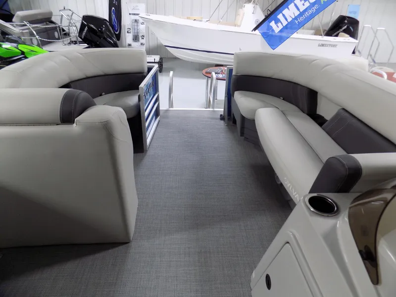 Slide: The Image of 2023 Sylvan 8522 Mirage Cruise pontoon boat interior with gray seating and carpet. - 8