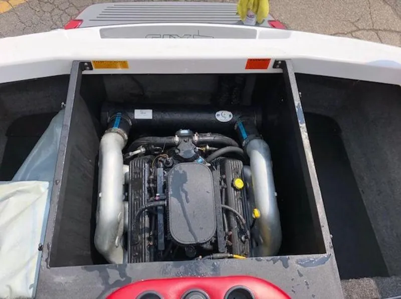 Slide: The Image of 2012 Axis Wake Research A-22 boat engine compartment with visible engine components. - 15