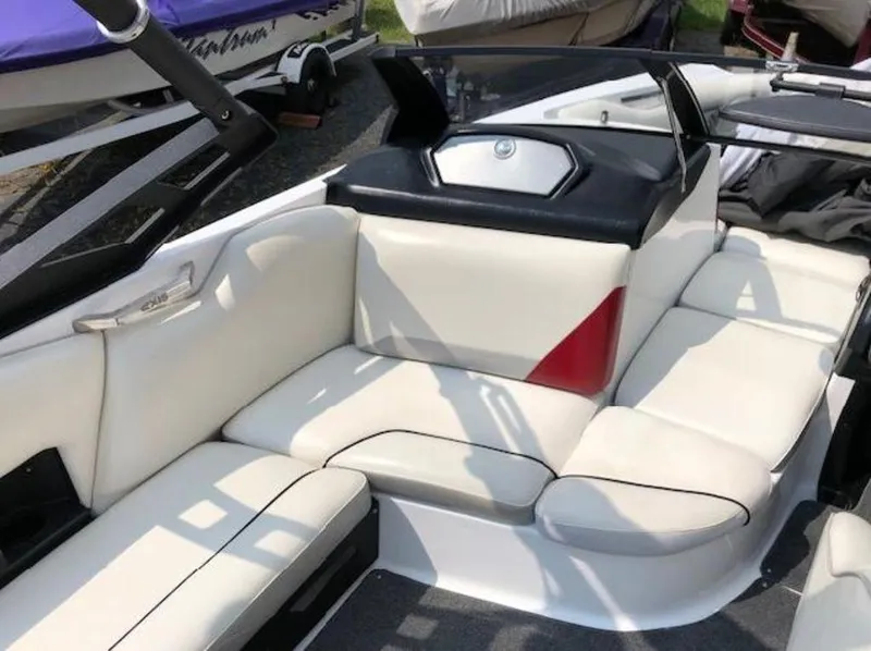 Slide: The Image of 2012 Axis Wake Research A-22 boat interior with white seating and red accents. - 19