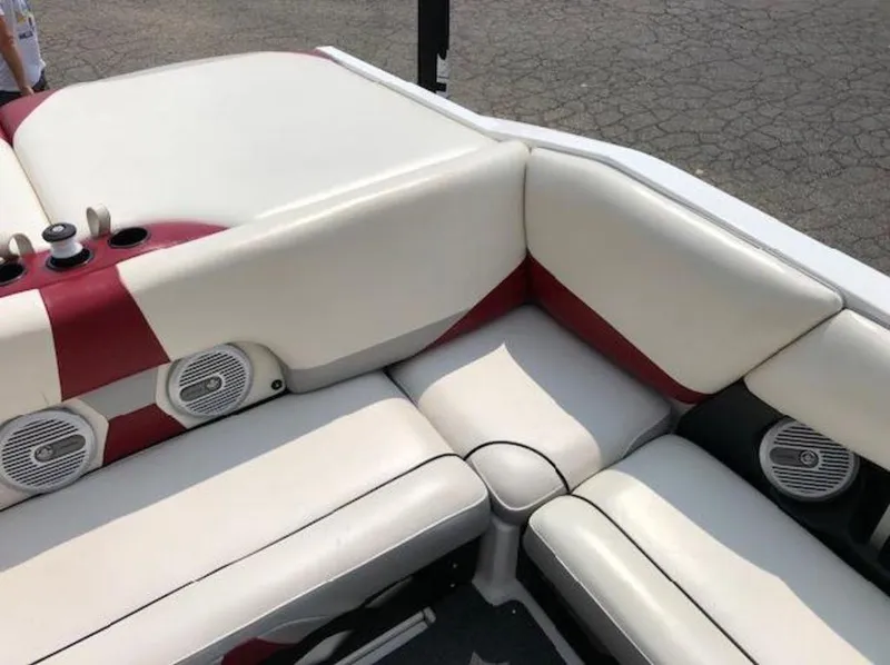 Slide: The Image of 2012 Axis Wake Research A-22 boat interior with white and red seating and built-in speakers. - 20
