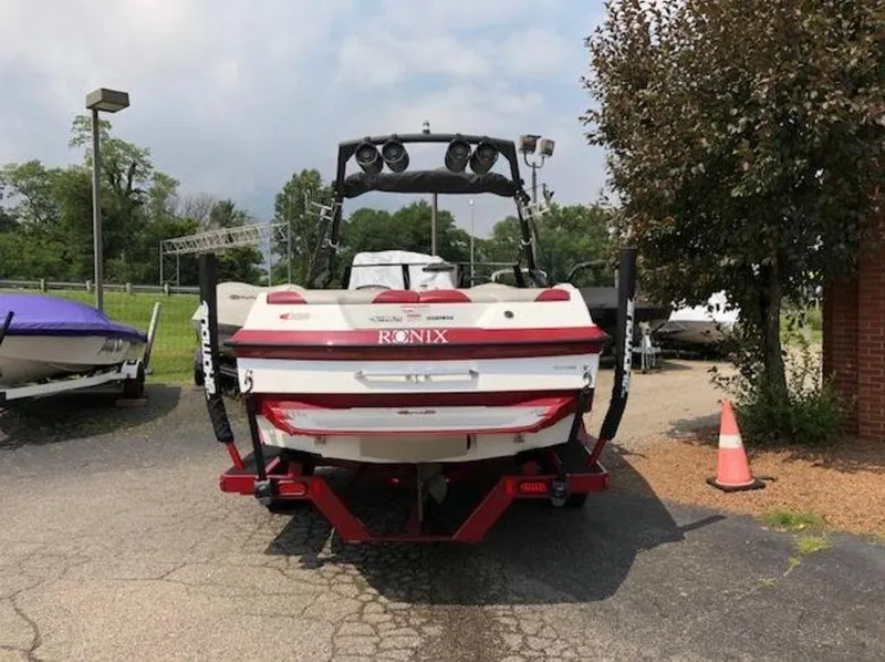 Slide: The Image of 2012 Axis Wake Research A-22 boat with Ronix branding, parked outdoors. - 25