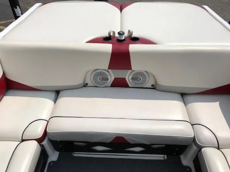 Slide: The Image of 2012 Axis Wake Research A-22 boat interior with white and red seating and built-in speakers. - 3