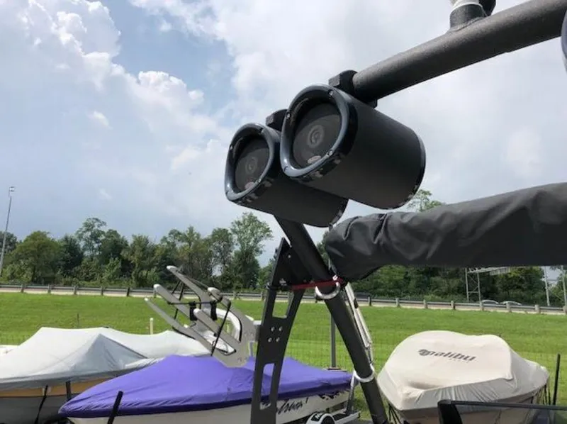 Slide: The Image of 2012 Axis Wake Research A-22 boat with mounted speakers, docked under a cloudy sky. - 35