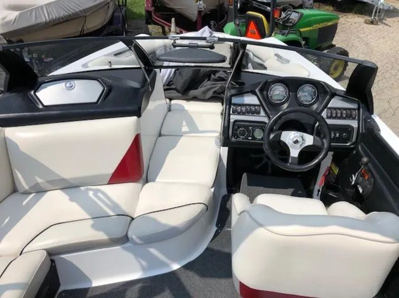 Slide: The Image of Interior of 2012 Axis Wake Research A-22 boat with white seating and modern dashboard. - 4