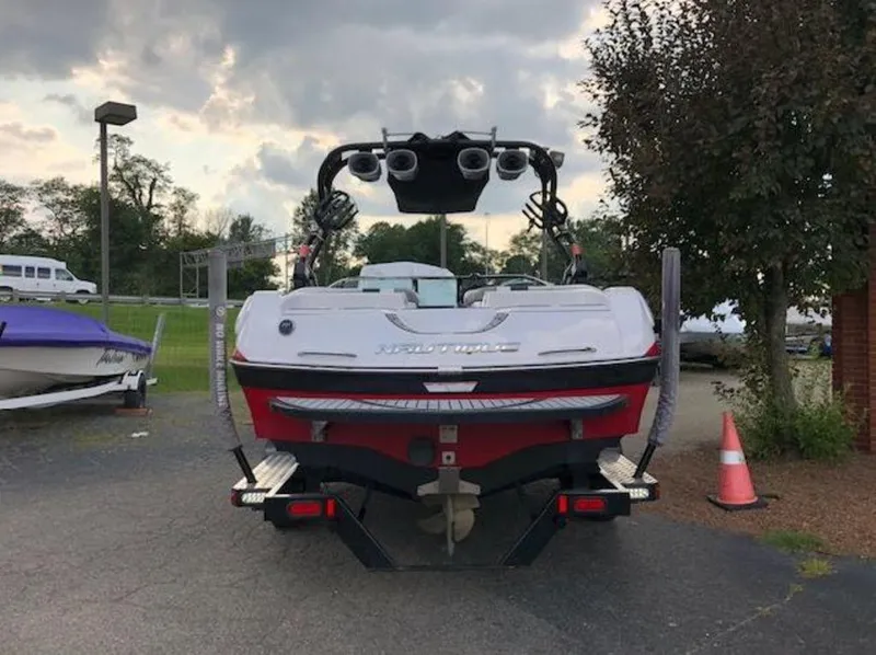 Slide: The Image of 2013 Nautique Super Air Nautique 230 boat, rear view, parked outdoors. - 10