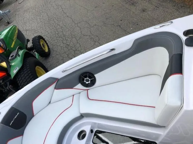 Slide: The Image of 2013 Nautique Super Air Nautique 230 boat interior with white and gray seating. - 15