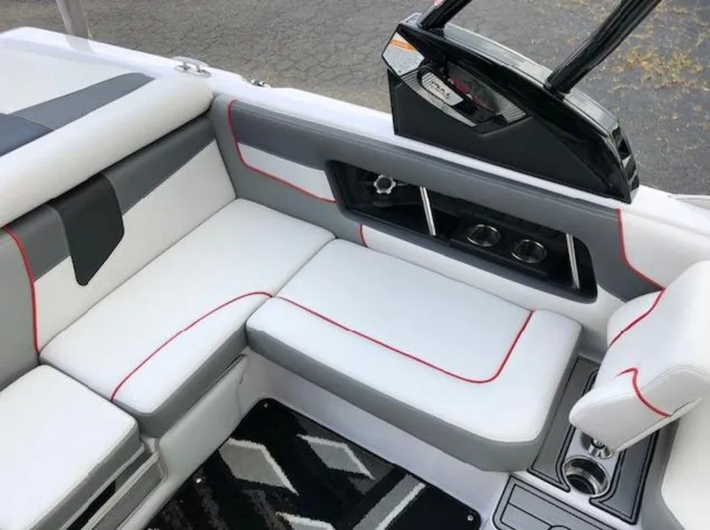 Slide: The Image of 2013 Nautique Super Air Nautique 230 interior with white and gray seating, red accents. - 17
