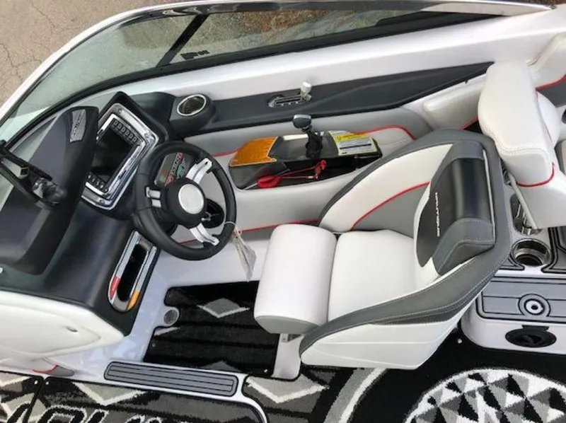 Slide: The Image of 2013 Nautique Super Air Nautique 230 boat interior with steering wheel and seating. - 18