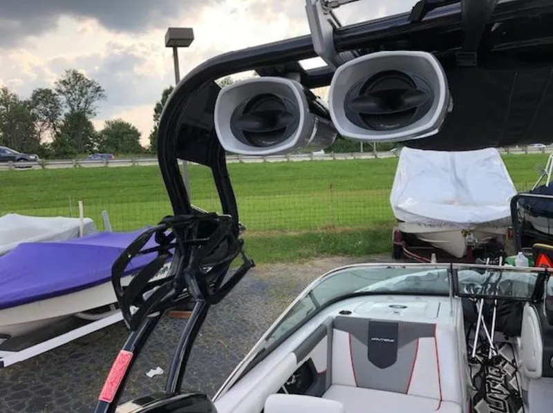 Slide: The Image of 2013 Nautique Super Air Nautique 230 boat with speakers and wakeboard rack. - 20