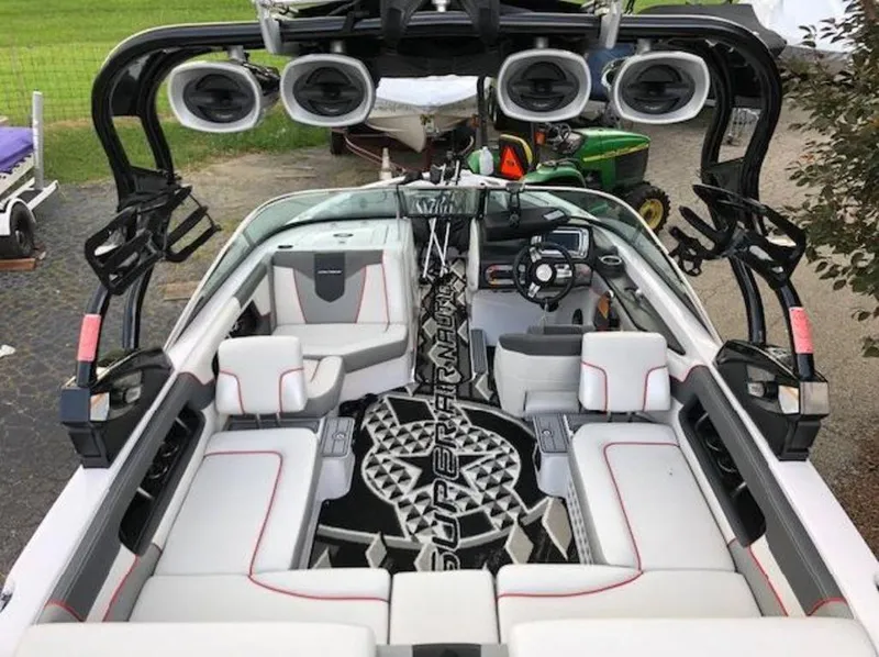 Slide: The Image of 2013 Nautique Super Air Nautique 230 interior with premium seating and advanced sound system. - 23
