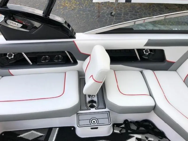 Slide: The Image of 2013 Nautique Super Air Nautique 230 interior with white and gray seating, red accents. - 3