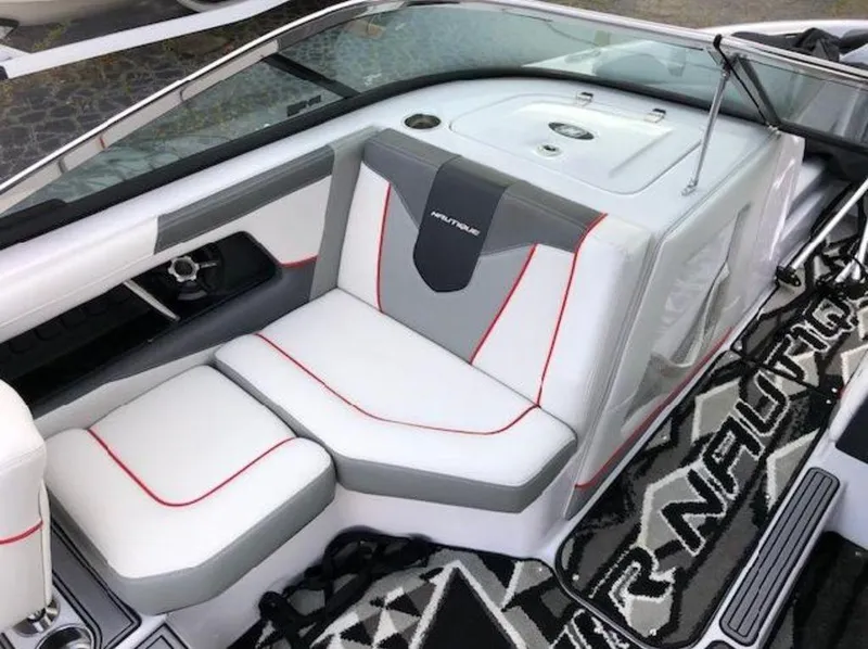 Slide: The Image of 2013 Nautique Super Air Nautique 230 interior with white and gray seating, red accents. - 35