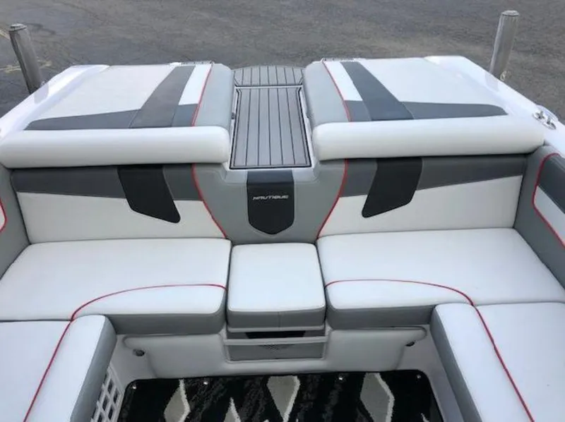 Slide: The Image of 2013 Nautique Super Air Nautique 230 boat interior with gray and white seating. - 8